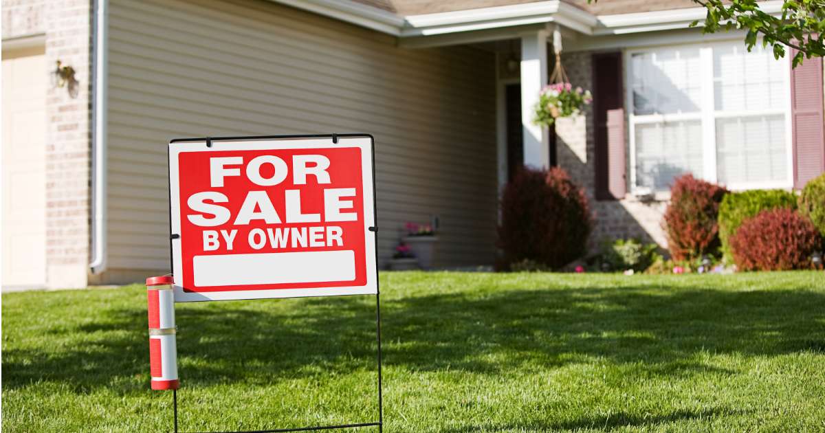 for sale sign in front of house