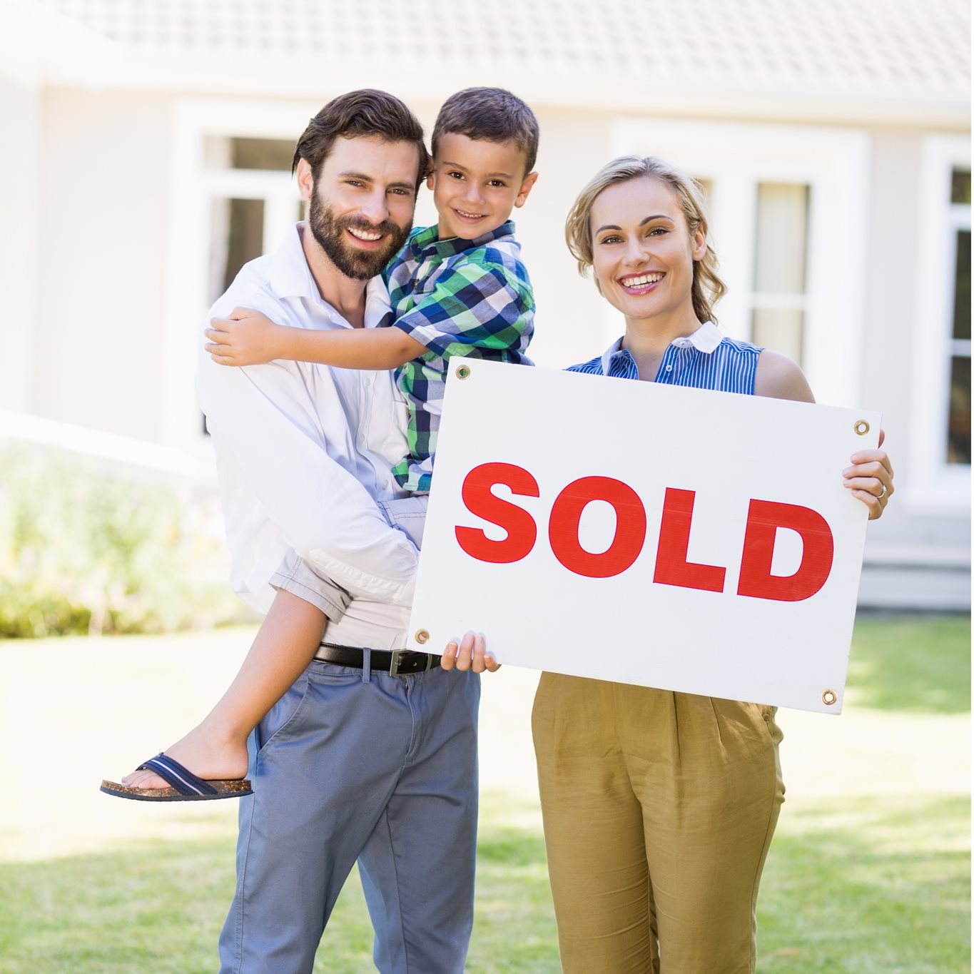 Family with sold sign