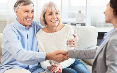 couple shaking hands with agent