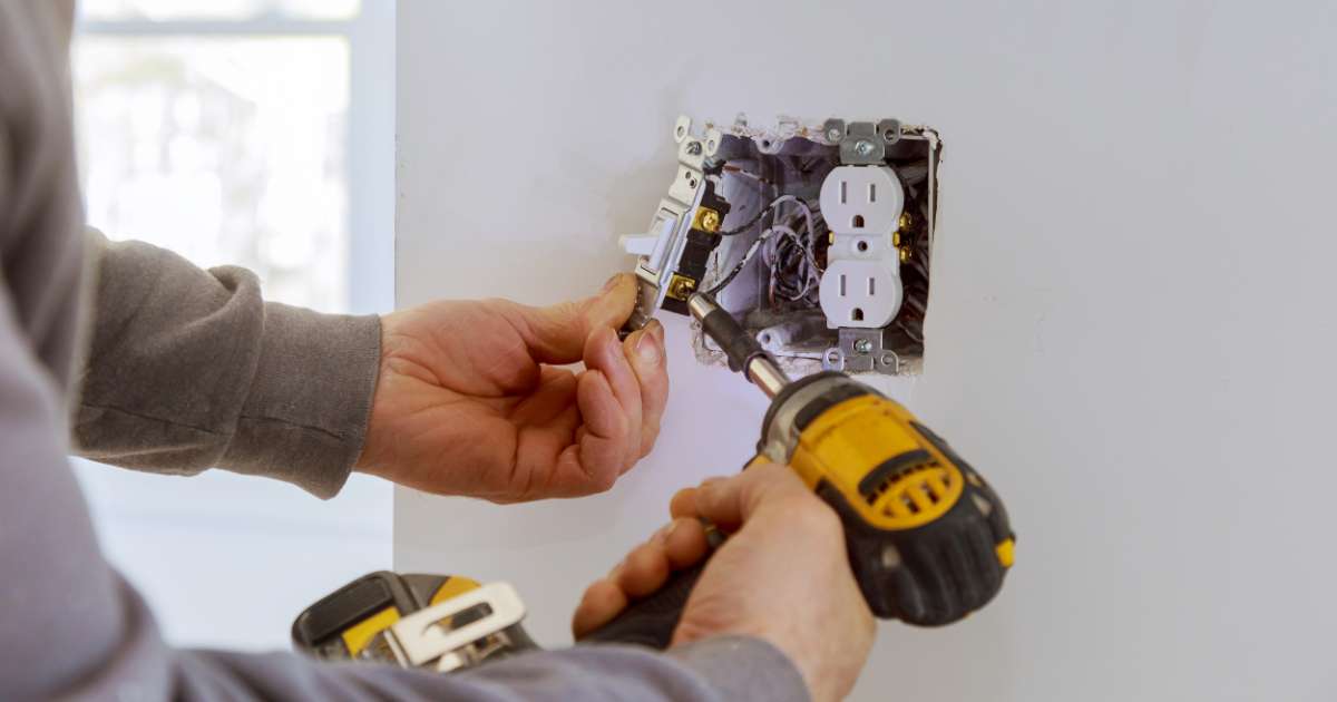 electrician fixing a light switch