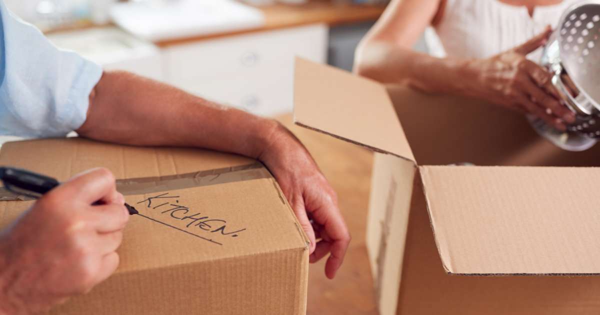 couple packing moving boxes