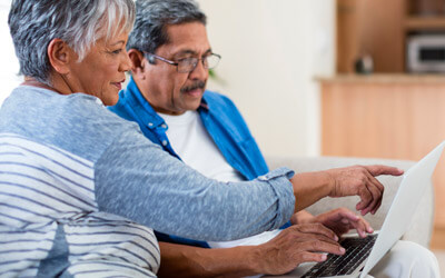 Couple looking at laptop screen together