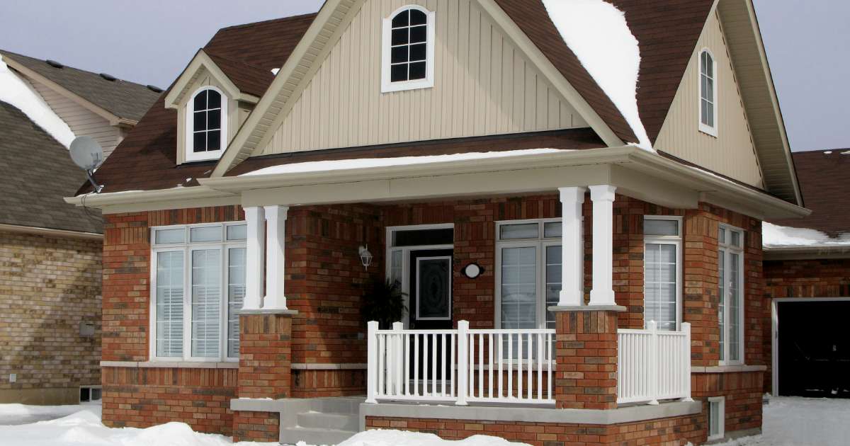 red brick house in snow