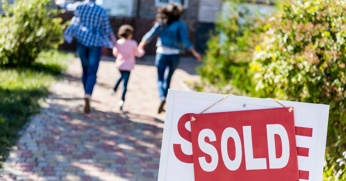family walking away from sold home