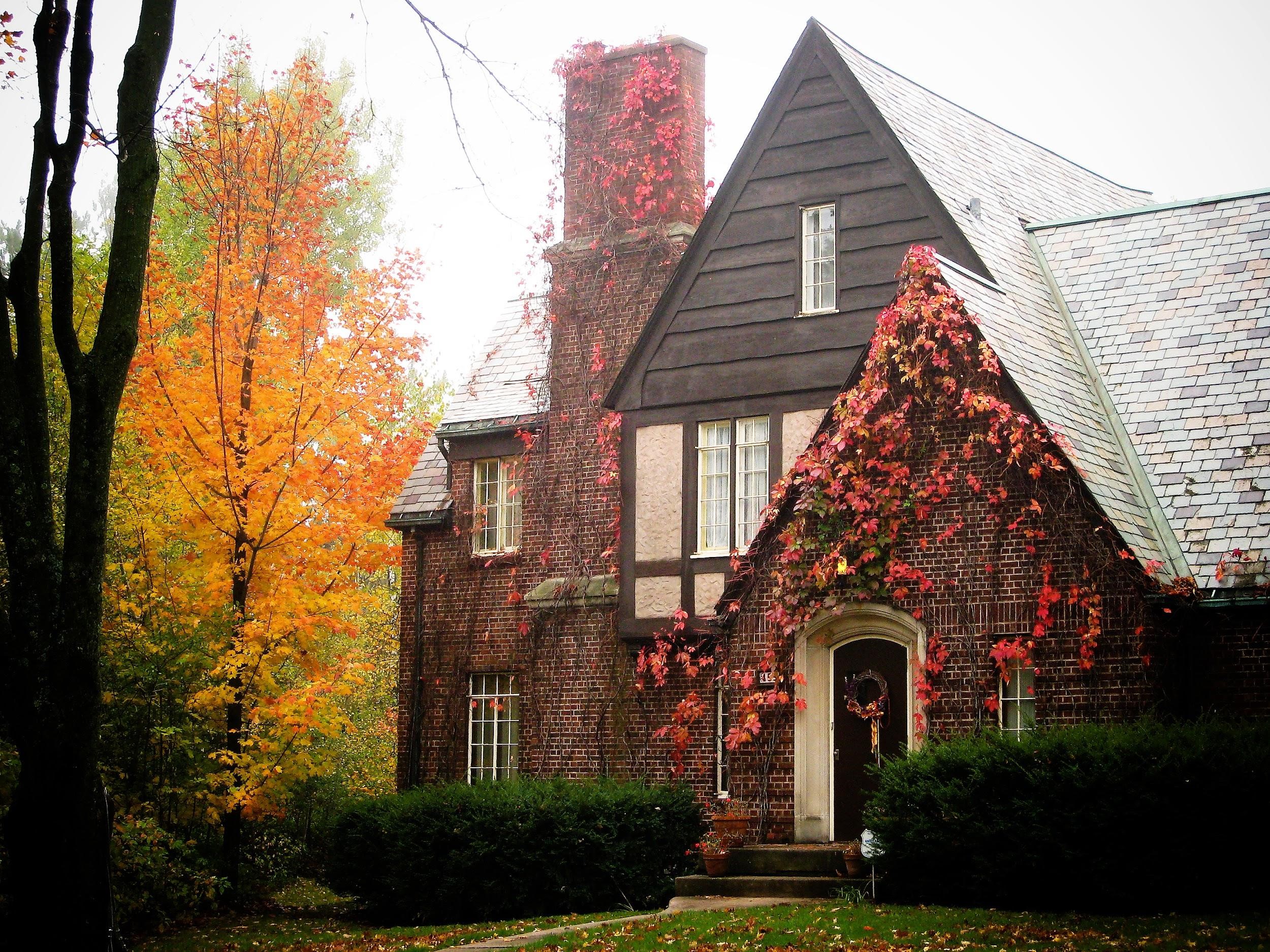 red brick house with fall foliage