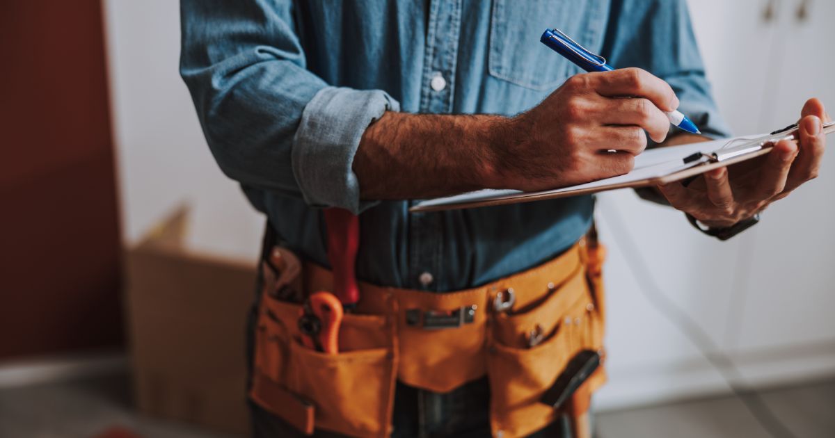 man with clipboard doing house inspection