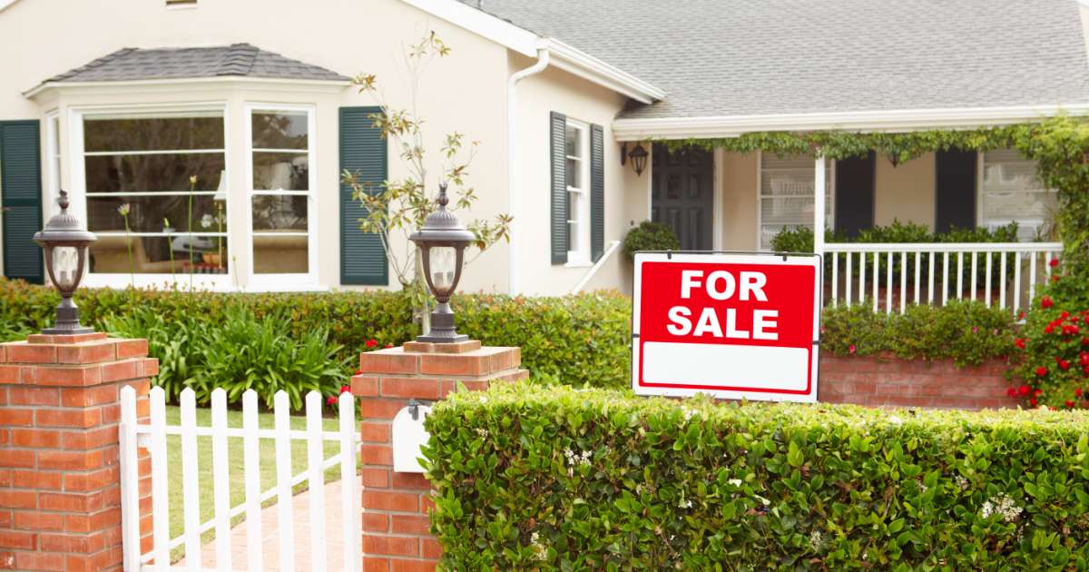 house with white fence for sale