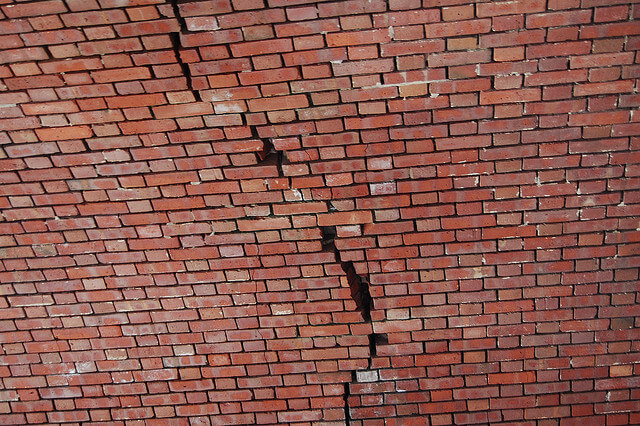 cracked red brick wall
