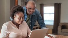 couple using computer to research the right time to sell their house