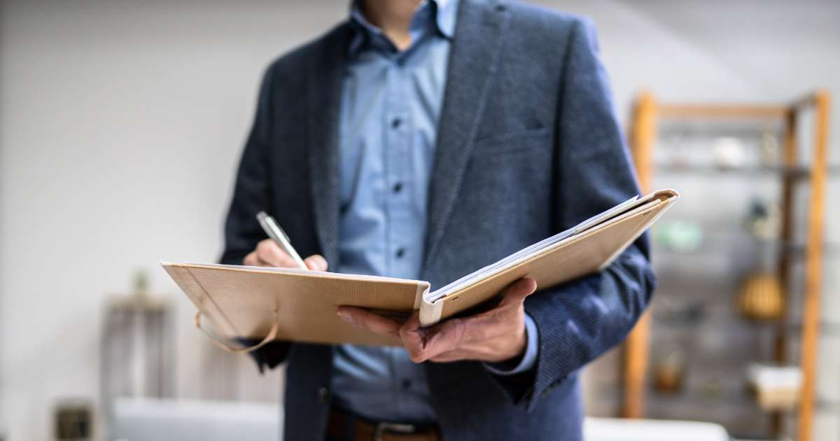 man signing house forms