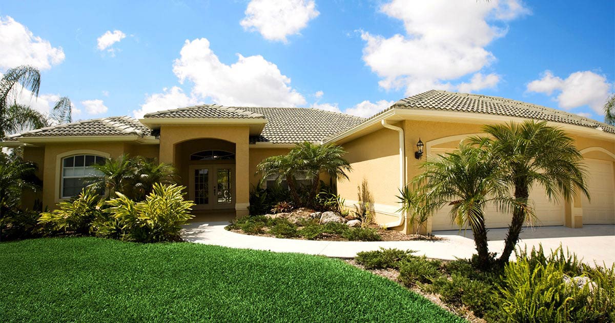 yellow house with palm trees
