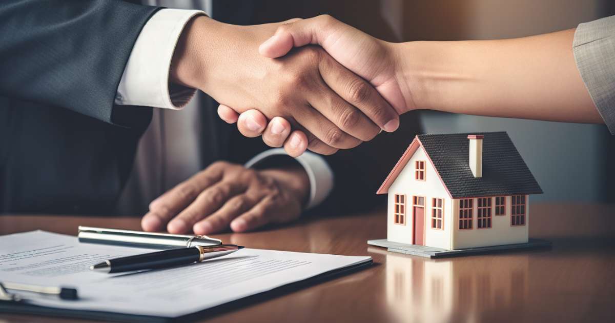 hand shake over house selling documents